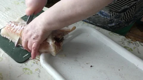 Home cooking process.  The cook is cleaning the cod fish.  Healthy food concept Video stock 136638150