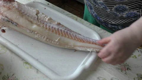 Home cooking process.  The cook is cleaning the cod fish.  Healthy food concept Stockbeeldmateriaal 136638736