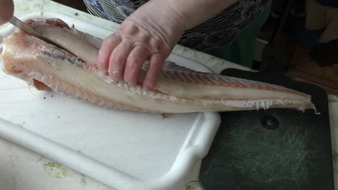 Home cooking process.  The cook is cleaning the cod fish.  Healthy food concept Stock-Footage 136638744