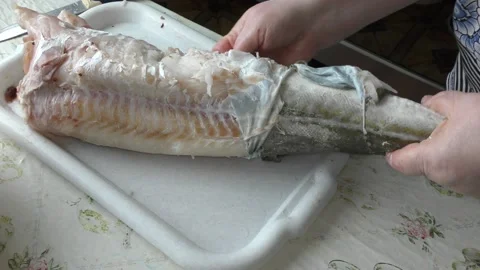 Home cooking process.  The cook is cleaning the cod fish.  Healthy food concept 스톡 동영상 136638840