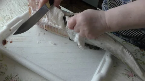 Home cooking process.  The cook is cleaning the cod fish.  Healthy food concept Video stock 136639151
