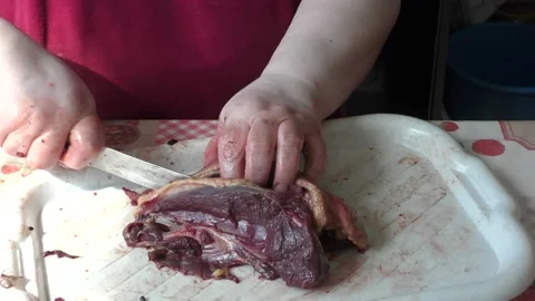 Home cooking process.  The cook cuts the goose into pieces. Stock Footage 155537361