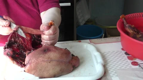 Home cooking process.  The cook cuts the goose into pieces. Stock Footage 155537645
