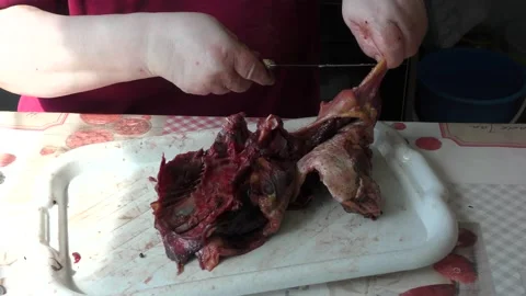 Home cooking process.  The cook cuts the goose into pieces. Stock Footage 155538206