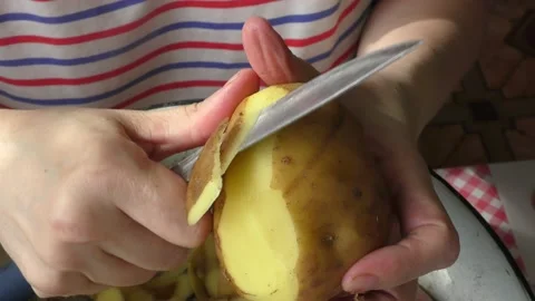 Home cooking process.  The cook is peeling potatoes.  Healthy food concept Stock Footage 155186918
