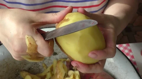 Home cooking process.  The cook is peeling potatoes.  Healthy food concept Video stock 155187561