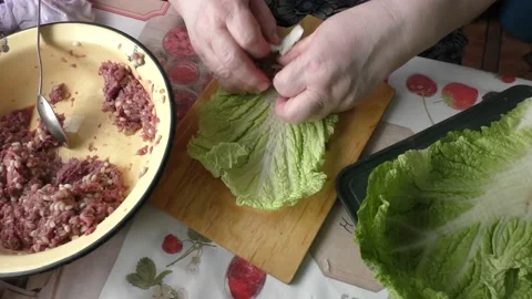 Home cooking process.  The cook prepares stuffed cabbage rolls from deer meat. Video stock 155202574