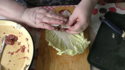 Home cooking process.  The cook prepares stuffed cabbage rolls from deer meat. Video stock 155203831
