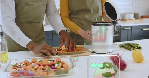 Home cooks using knife, slicing potatoes, composting peels with eco icons for Stock Footage 319678278