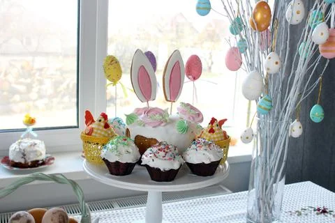 Home decor at Easter. Easter eggs hang on the branches of a tree standing in Stock Photos