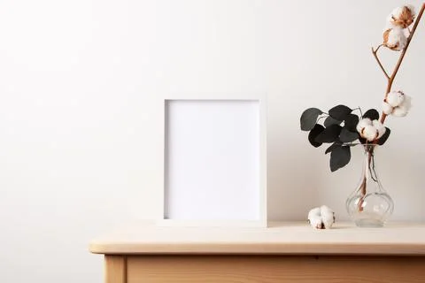 Home decoration with white mock up frame on table. Artwork showcase. Scandina Stock Photos