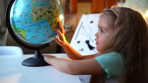 Home education for children girl shows country on globe. Student Child Studying Vidéo 169661200