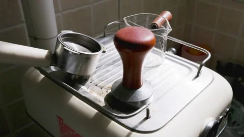 Home espresso machine with coffee tamper and portafilter in kitchen Stock Footage 345419537