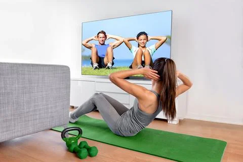 Home fitness concept. Woman doing strength training abs situps bodyweight floor Stock Photos