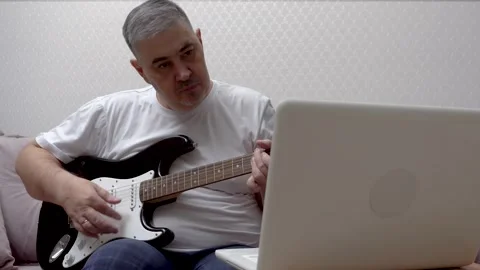 Home Guitar Practice - Man Learning to Play Guitar Online Stock Footage 288245877