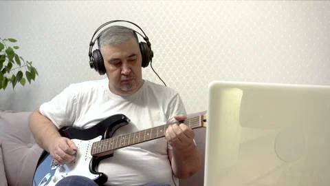 Home Guitar Practice - Man Learning to Play Guitar Online Stock Footage 288246286