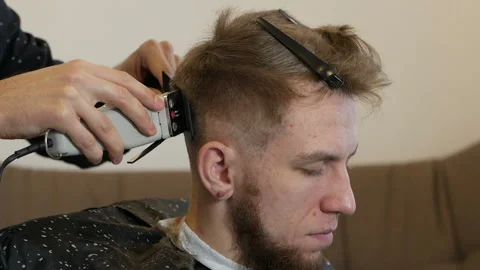 At home handsome guy have a professional haircut Stock Footage 149759092