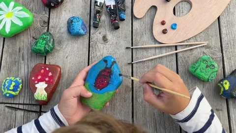 Home hobbies are authentic. Artwork on stones. Stock Footage 209627416