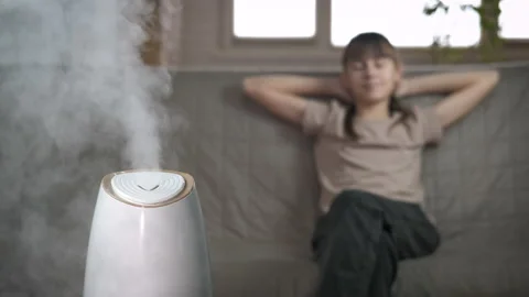 Home humidifier. Girl by aromatherapy diffuser. Stock Footage 171946654