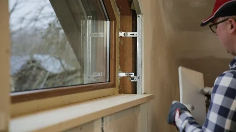 Home improvement handyman installing window Stock Footage 123248919