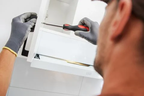 Home Improvement Project Involving Cabinet Installation With a Screwdriver Foto stock