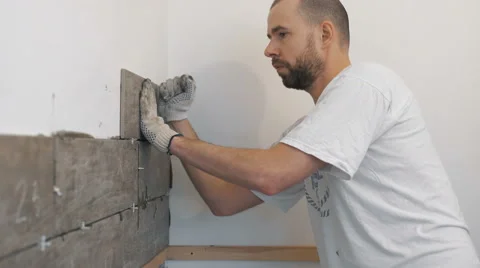 Home improvement, renovation - construction worker tiler is tiling, ceramic tile Stock Footage 59947331