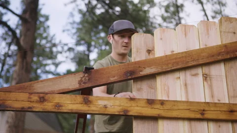 Home Improvement Scene of Man Installing Fence Board Stock Footage 315928283