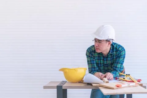 Home improvement worker is working on workshop table with tools and instrumen Stock Photos