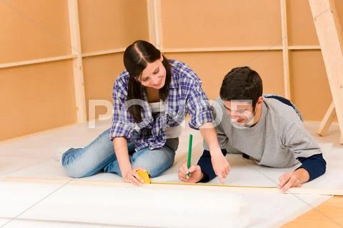 Home improvement young couple work on renovations Stock Photos