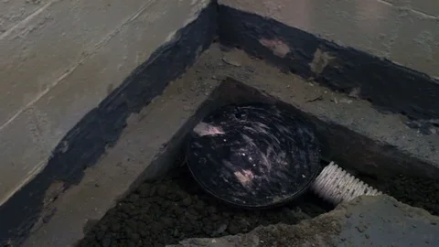 Home Inspector excamining interior sump pump from french drain in unfi Stock Footage 70238237
