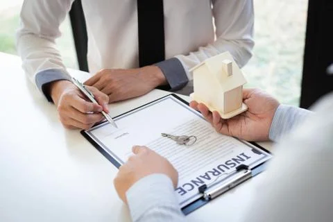 Home insurance agents offer terms and conditions to clients and get approval, Stock Photos