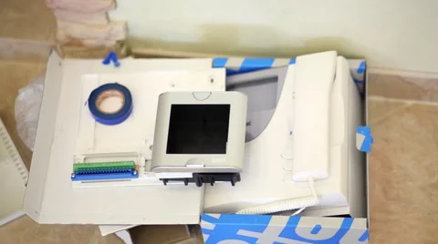 Home intercom package in open cardboard box on the floor. Stock Footage 51876096