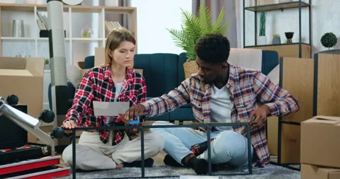 Home interior concept where good-looking positive happy modern mixed race couple Stock Footage 158565750