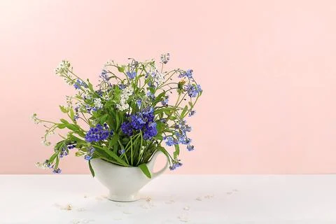 Home interior with decor elements, beautiful spring garden flowers in a va... Stock Photos