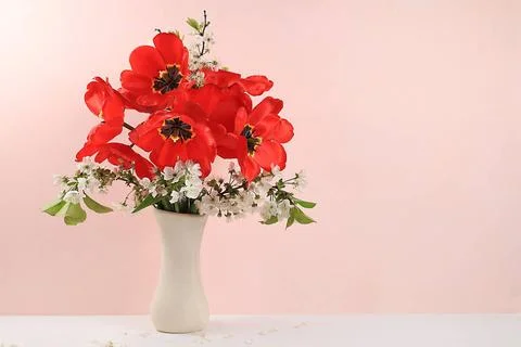 Home interior with decor elements, beautiful spring garden flowers in a va... Stock Photos