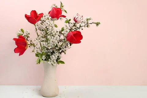 Home interior with decor elements, beautiful spring cherry branches and tu... Stock Photos