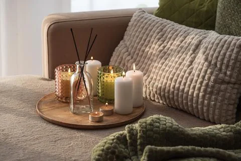 Home interior decor setup with scented candles and diffuser on a tray cozy .. Stock Photos