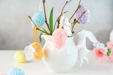 Home interior with easter decor. Vase with willow tree branches with Easter eggs Stock Photos