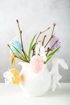 Home interior with easter decor. Vase with willow tree branches with Easter eggs Stock Photos