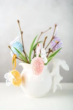 Home interior with easter decor. Vase with willow tree branches with Easter eggs Stock Photos