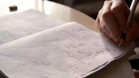 Home interior student does his math homework at home. Learning math Video stock 314234249