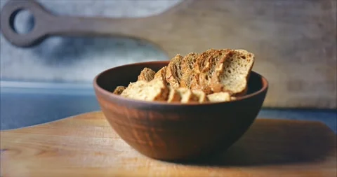 Home kitchen. Baked crackers from rye baguette in a clay plate Stock Footage 273490544