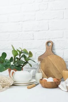 Home kitchen interior with easter decor. Blooming flower in a pot, eggs in wo Stock Photos