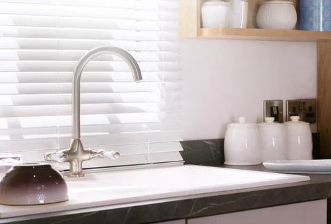 Home kitchen interior featuring kitchen sink basin and marble counter Fotos Stock