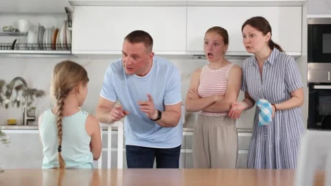 At home kitchen parents scold standing female child for bad behavior at school 動画素材 304709244