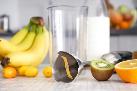 Home kitchen with ripe fruit table and hand blender. Close-up. Stock Photos