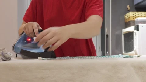 Home kitchen towel ironing routine close up Stock-Footage 337950449