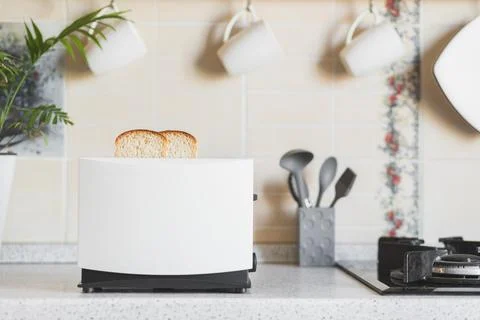 Home kitchen work surface with toaster and kitchen utensils, part of cozy Stock Photos