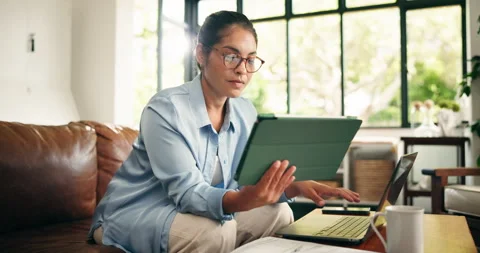 Home, laptop and woman with tablet, typing and multitasking for story research, Stock Footage 329433341
