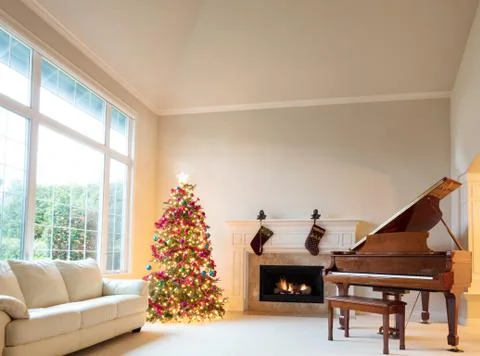 Home living room decorated with Christmas tree and hanging stockings o Stock Photos